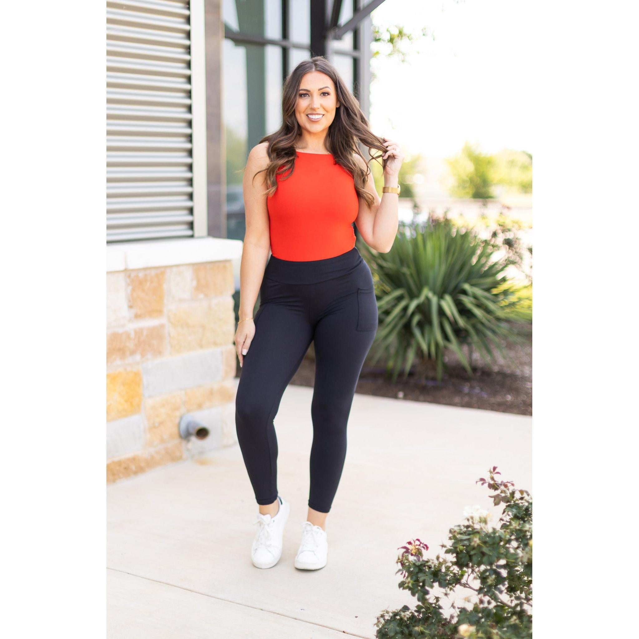High-waisted black ankle length leggings with pockets by Julia Rose, Julia Rose women’s black 7/8 leggings lifestyle image