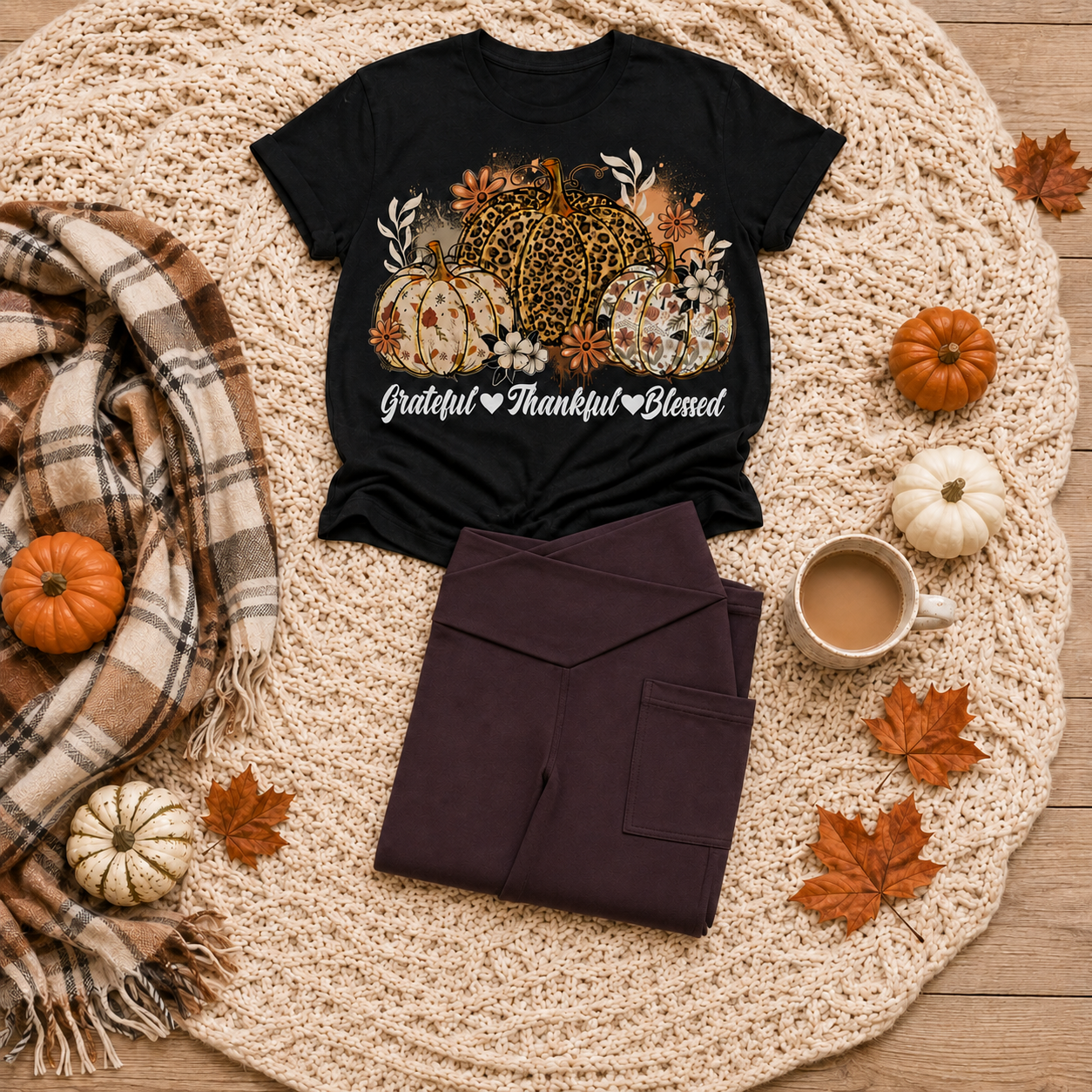 Black crewneck T-shirt featuring leopard and floral pumpkins with white Grateful Thankful Blessed script, styled with folded brown leggings in a fall flat lay.