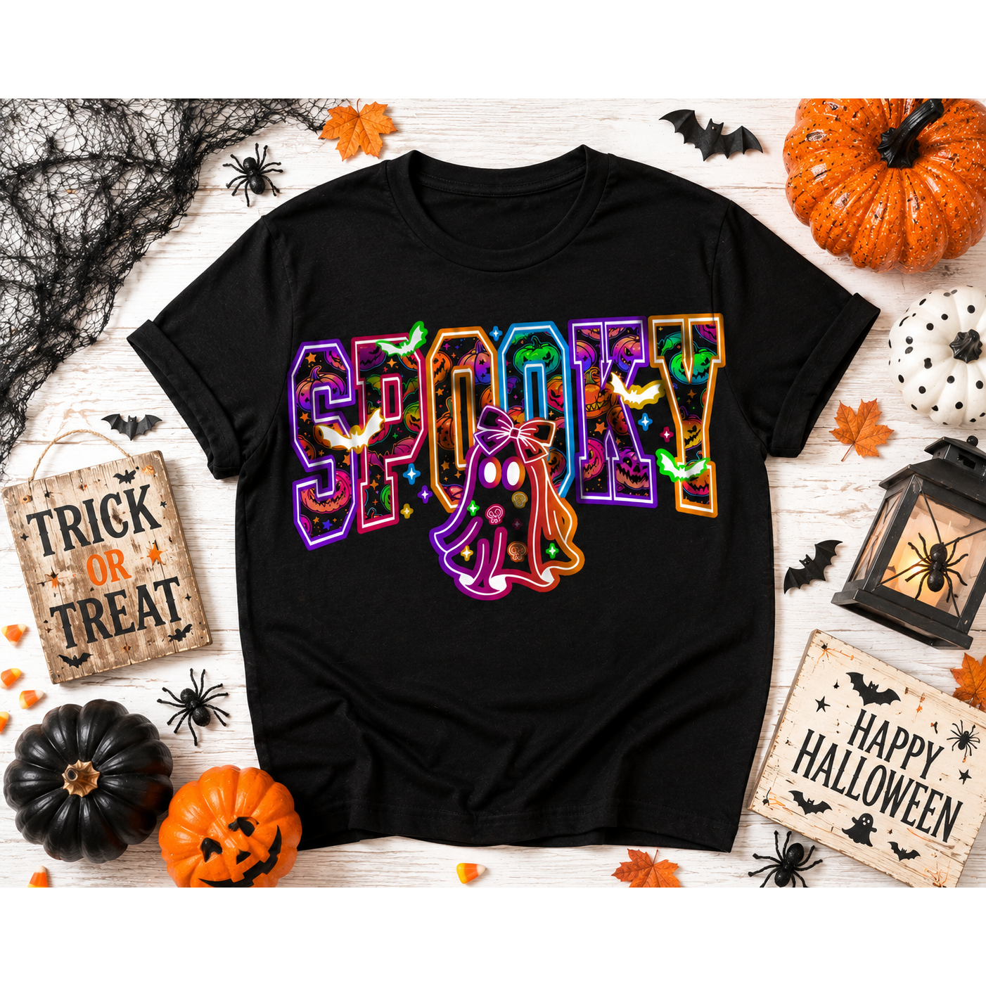 Black crew-neck Halloween shirt featuring colorful SPOOKY lettering with pumpkins, bats, candy, and a trick-or-treating ghost graphic.