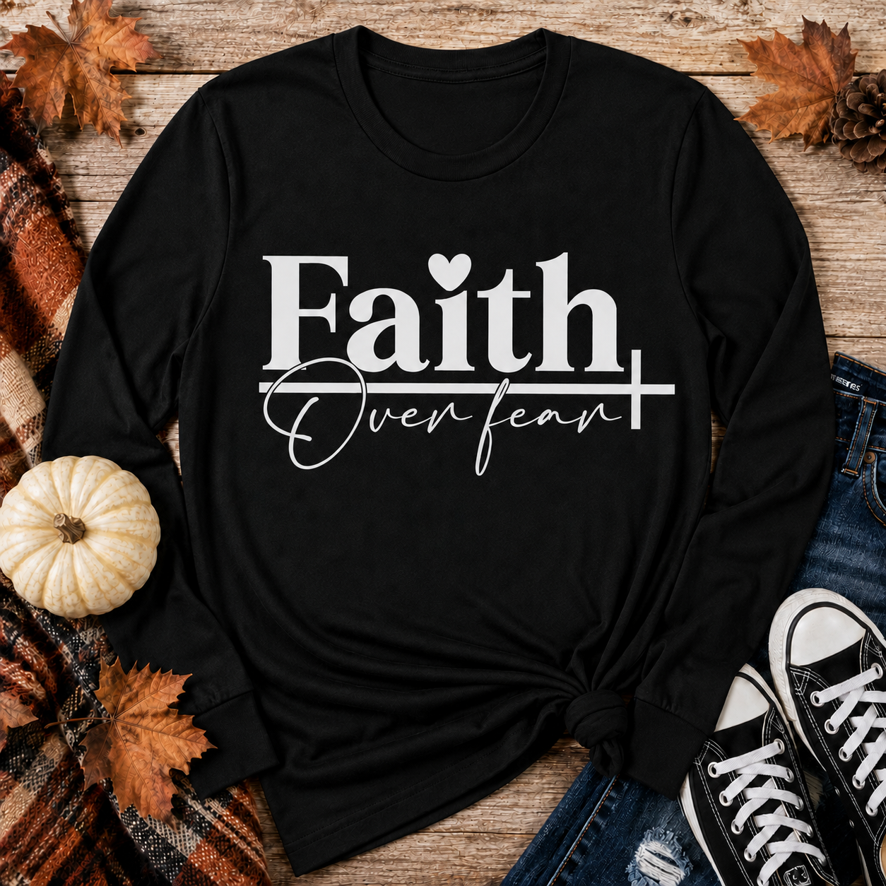 Julia Rose Faith Over Fear apparel featuring a white heart and cross design, available as a crewneck, V-neck, long-sleeve T-shirt and hoodie.
