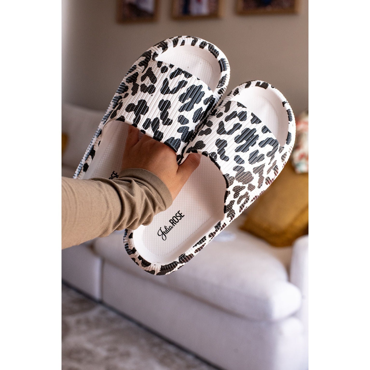 White leopard-print beach slides with a bold spotted pattern and easy slip-on design