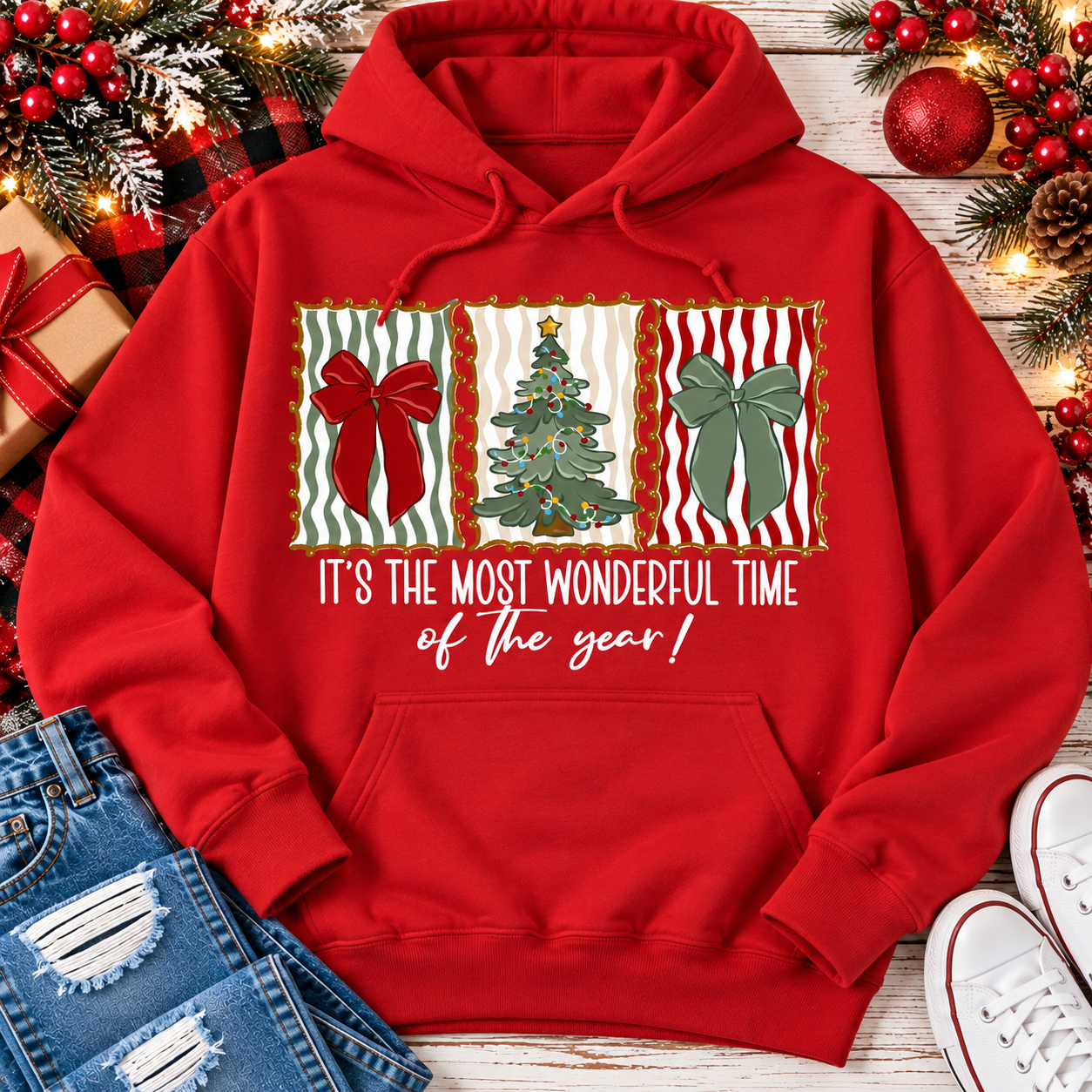 Red Christmas hoodie with festive bow and Christmas tree artwork in vintage holiday frames and It's the Most Wonderful Time of the Year graphic.