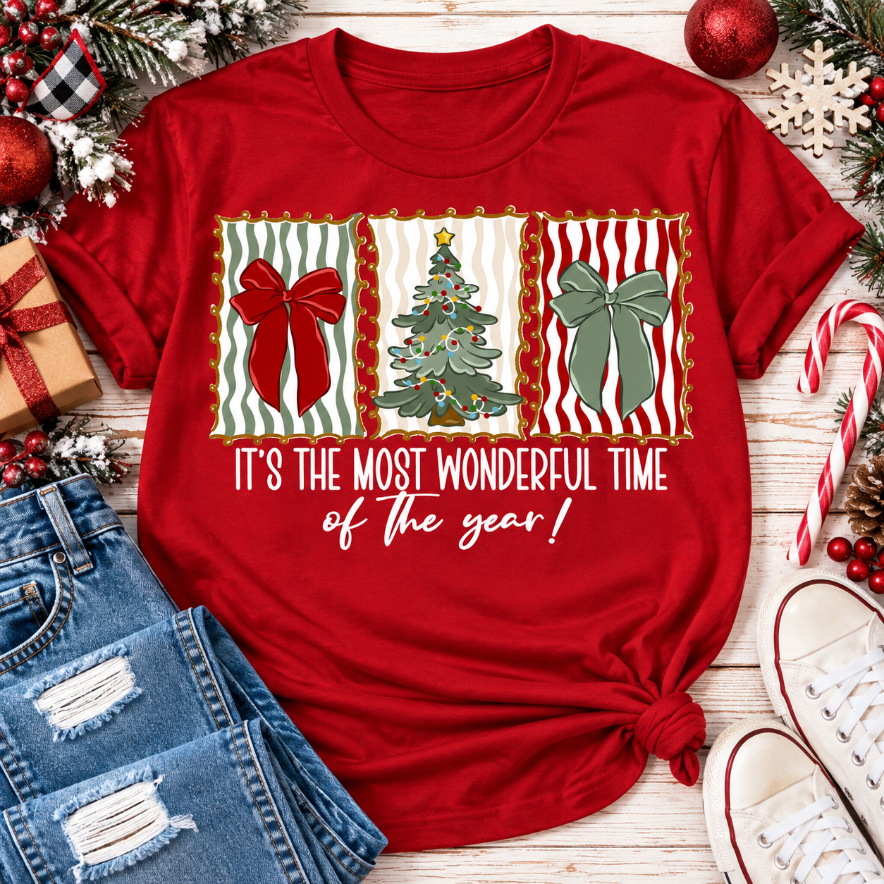 Red Christmas graphic tee featuring festive red and green bows, Christmas tree and holiday typography.