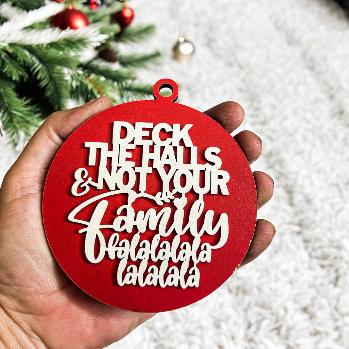 Red Christmas ornament with humorous text held in front of a decorated tree.
funny gifts delivered
funny gifts for girlfriend
funny gifts for boss
funny ornaments tree
funny hood ornaments
red christmas tree decor
white and red christmas tree decor