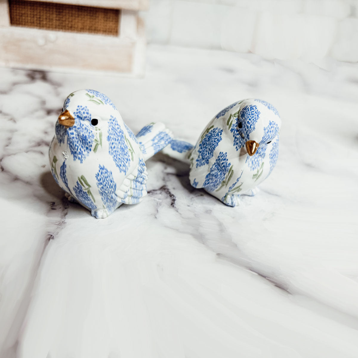 Elegant resin bird figurines with floral designs, perfect for nature-inspired decor themes