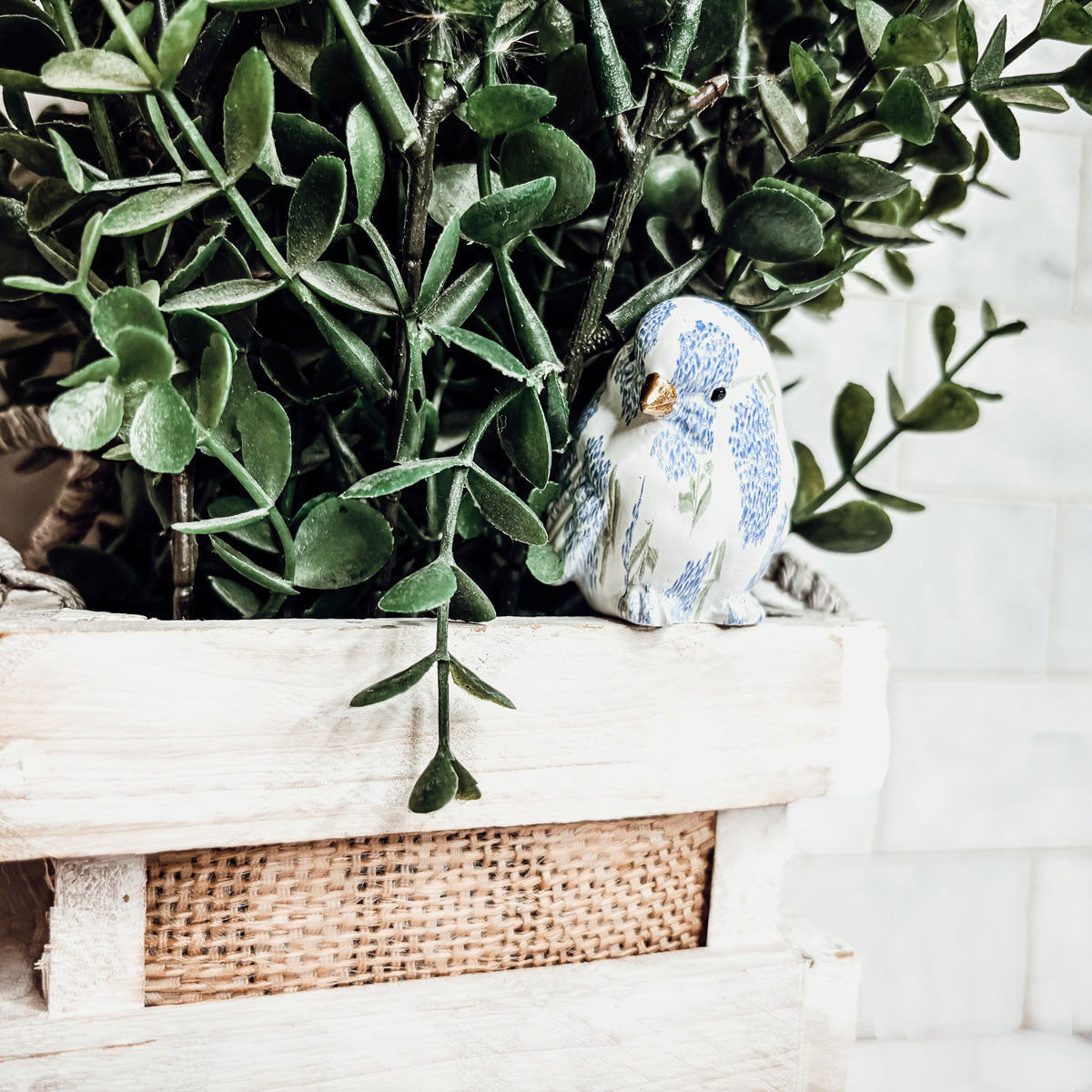 Close-up of blue hydrangea bird figurines, showcasing detailed craftsmanship and vibrant colors