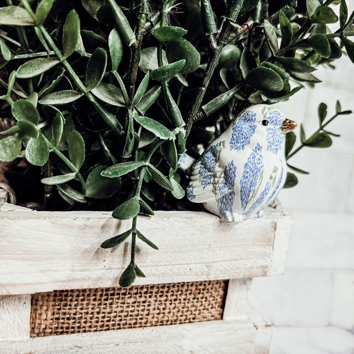 Blue hydrangea bird figurines displayed on a kitchen counter, enhancing home aesthetics