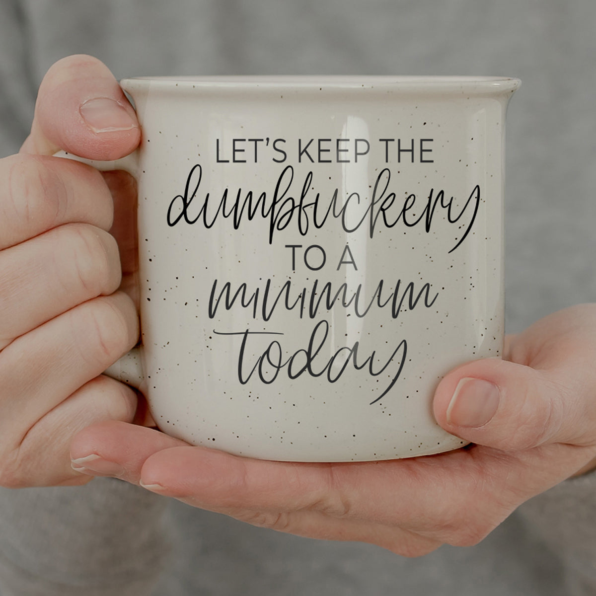 Funny white ceramic coffee mug with minimalist typography saying lets keep the dumbf*ckery to a minimum today