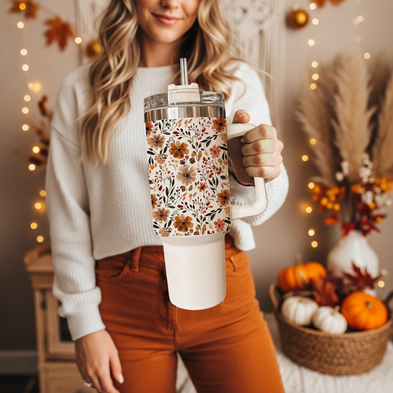 Stay cozy all autumn long with this beautiful floral fall 40oz tumbler featuring a warm neutral flower pattern and insulated stainless steel design. Perfect for iced coffee, tea, water, or seasonal drinks, this handled tumbler keeps beverages hot or cold for hours and includes a reusable straw with spill-resistant lid. 