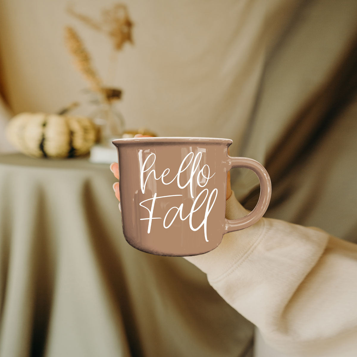 hello fall autumn drinkware in cozy living room
hello fall mug with gold spoon and saucer
hello fall mug on window sill with rainy day view
hello fall mug with burnt orange throw pillow
hello fall mug next to apple cider donuts
hello fall coffee cup with gingham napkin
hello fall mug in thanksgiving table place setting
hello fall mug by fireplace with stacked wood