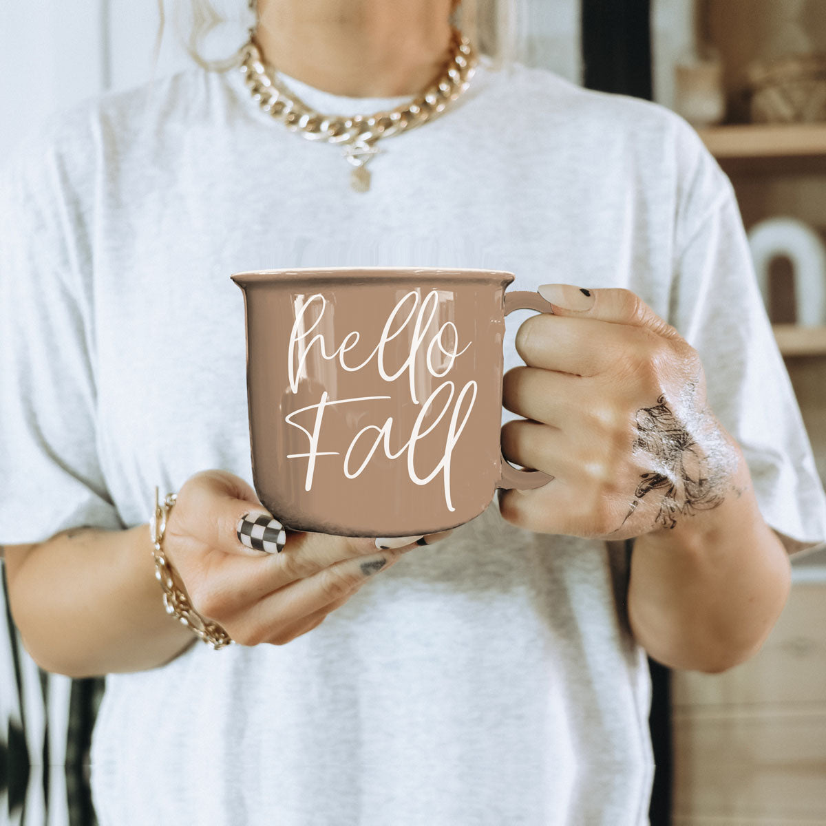 hello fall coffee cup on wicker tray
hello fall mug in fall bedroom nightstand decor
hello fall mug on porch with pumpkins and mums
hello fall mug in fall kitchen window light
hello fall coffee cup in neutral boho living room
hello fall mug with caramel drizzle latte on saucer