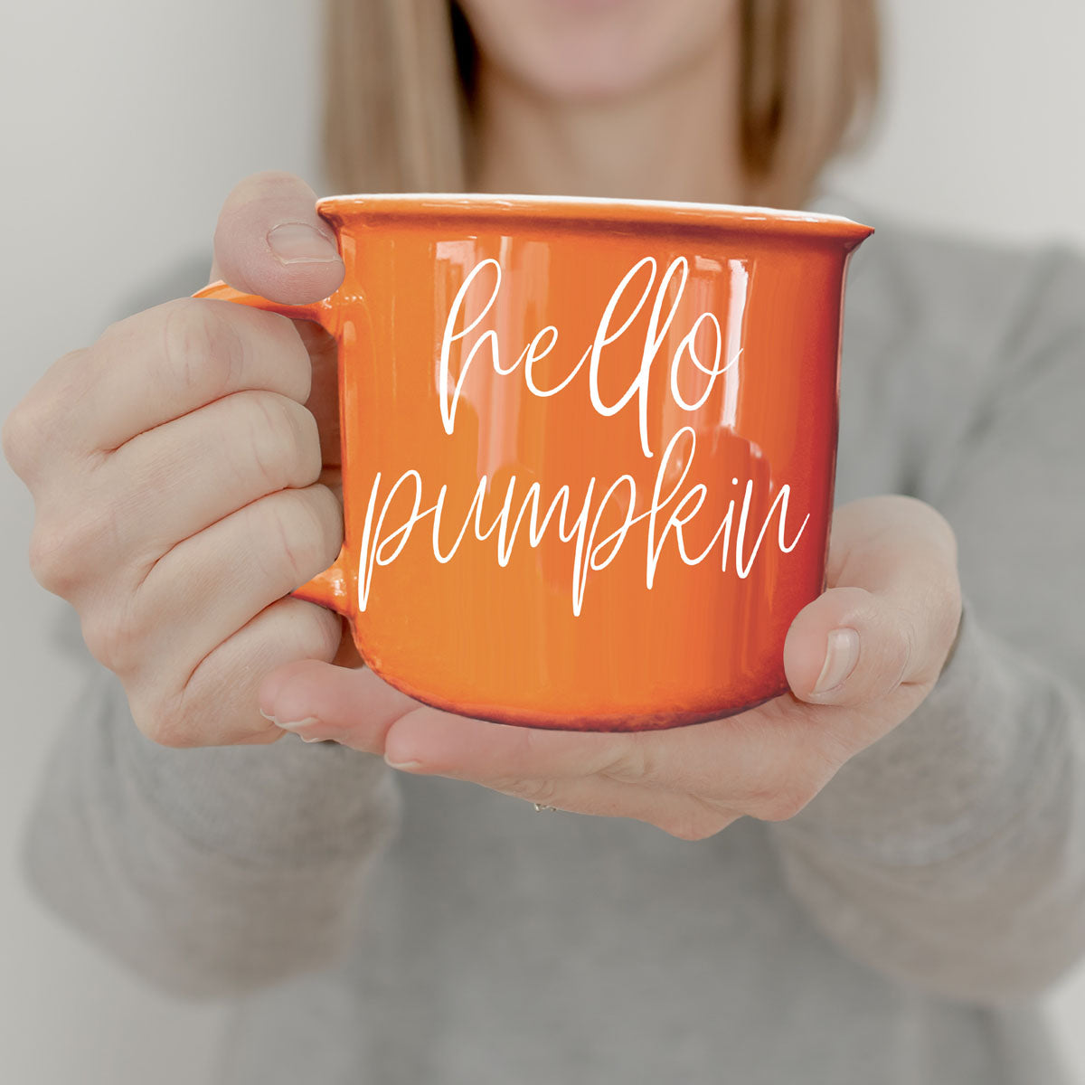 fall flatlay with orange coffee cup and leaves
orange mug for halloween and thanksgiving season
cozy reading nook with orange coffee mug
autumn picnic scene with orange mug