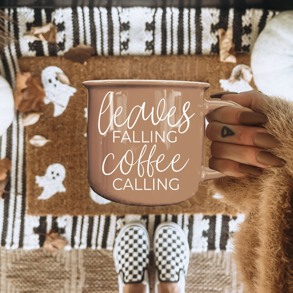 leaves falling coffee calling mug on marble countertop
autumn coffee cup with warm brown tones and fall decor
brown fall mug with chain and pumpkin styling
leaves falling coffee calling mug for fall coffee bar