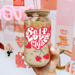 Self love club glass cup 20oz. 
20oz glass cups with bamboo lid and glass straw featuring "Self Love Club" and red heart cherry graphics.
Retro "Self Love Club" 20oz glass cups with bamboo lid, glass straw, and gold glitter hearts.