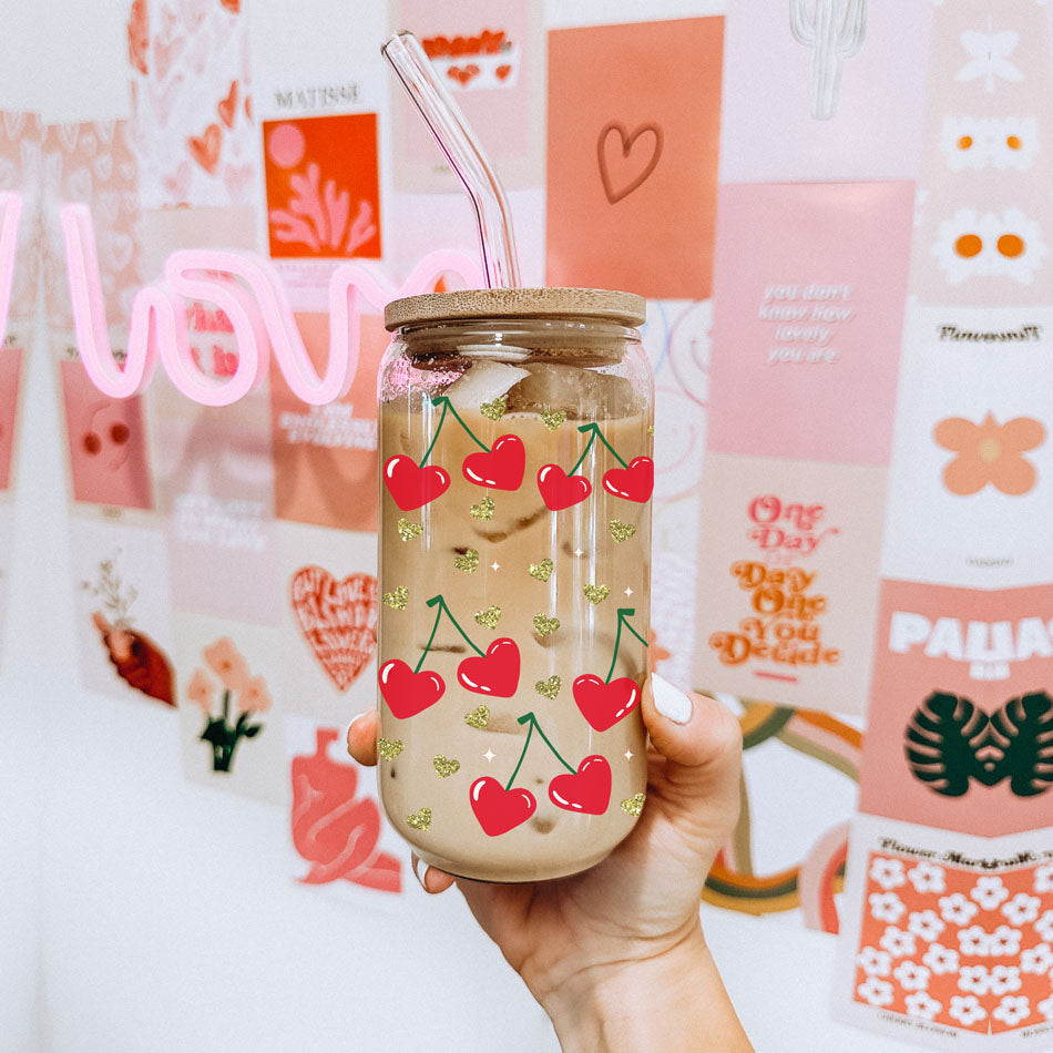 Chic 20oz glass cups with bamboo lid and glass straw, featuring red heart and cherry graphics.
