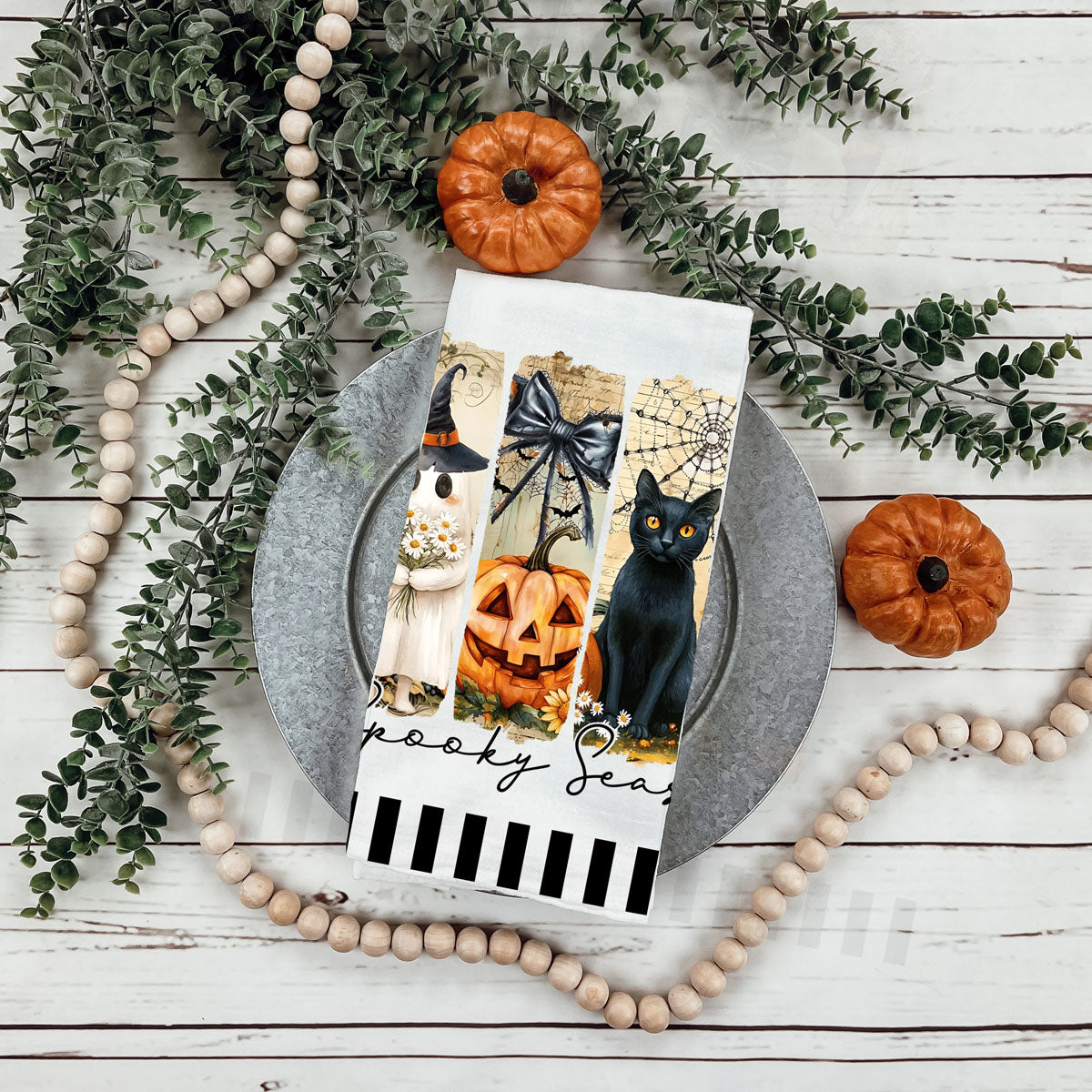 cute ghost halloween towel for non scary spooky décor
floral ghost and pumpkin halloween cotton kitchen towel
spooky season tea towel with cobwebs and gravestone art
playful spooky season towel for fun modern halloween decorating