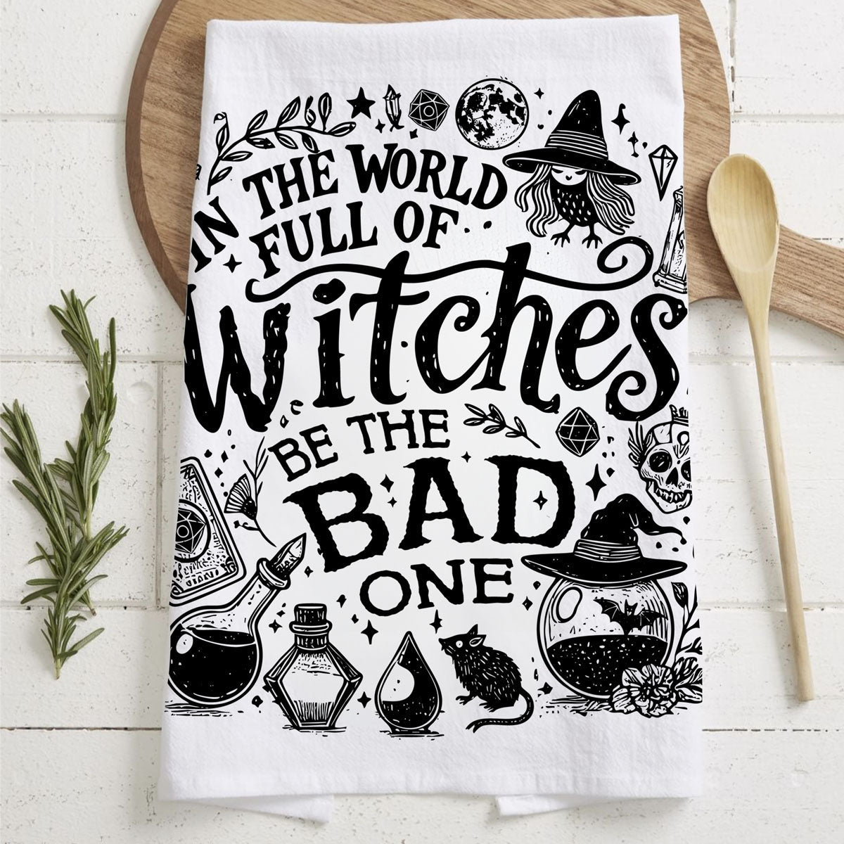 sarcastic witchy style to your kitchen with this funny Halloween towel. One side reads “In a world full of witches be the bad one” and the other says “Bitchcraft – the art of pissing people off and smiling sweetly.” Printed in black on soft, absorbent flour sack cotton, this humorous witch kitchen towel is perfect for Halloween décor, witchcore kitchens, hostess gifts and funny gifts for snarky friends who love spooky season.